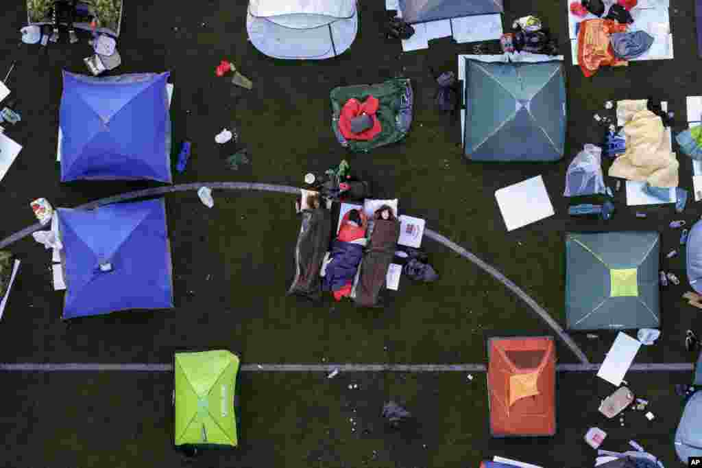 Students sleeping in their tents on a soccer stadium as they take part in a march and protest over the collapse of a concrete canopy that killed 15 people more than two months ago, in Indjija, Serbia.