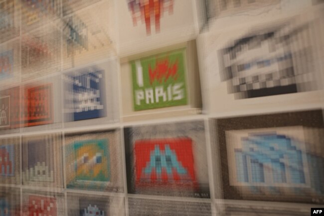 FILE - Artworks are exhibited at the "Space Invader Station" exhibition of street artist Invader in Paris, on February 27, 2024. (Photo by Thomas SAMSON / AFP) /