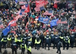 Trump supporters clash with police and security forces as they storm the US Capitol in Washington, DC on January 6, 2021. - Donald Trump's supporters stormed a session of Congress held today, January 6, to certify Joe Biden's election win,…