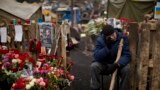 An anti-Yanukovych protester cries near a memorial for the people killed in clashes in Kyiv's Independence Square, Feb. 25, 2014.