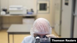 FILE PHOTO: A specialist works at Binnopharm pharmaceutical plant which develops "Gam-COVID-Vac" vaccine against the coronavirus disease near Moscow