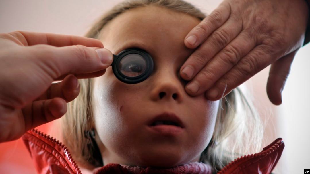 FILE - A girl's eyes are examined March 8, 2012.