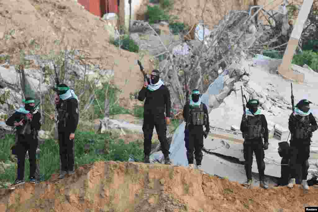 Palestinian Hamas militants keep guard on the day Hamas hands over deceased hostages Oded Lifschitz, Shiri Bibas and her two children Kfir and Ariel Bibas,&nbsp;seized during the deadly October 7, 2023 attack, to the Red Cross, in Khan Younis in the southern Gaza Strip.