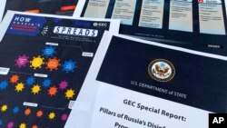 Pages from the U.S. State Department's Global Engagement Center report released on Aug. 5, 2020, are seen in this photo. 