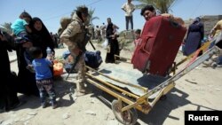 Displaced Sunni people fleeing the violence in the city of Ramadi arrive at the outskirts of Baghdad, May 16, 2015.