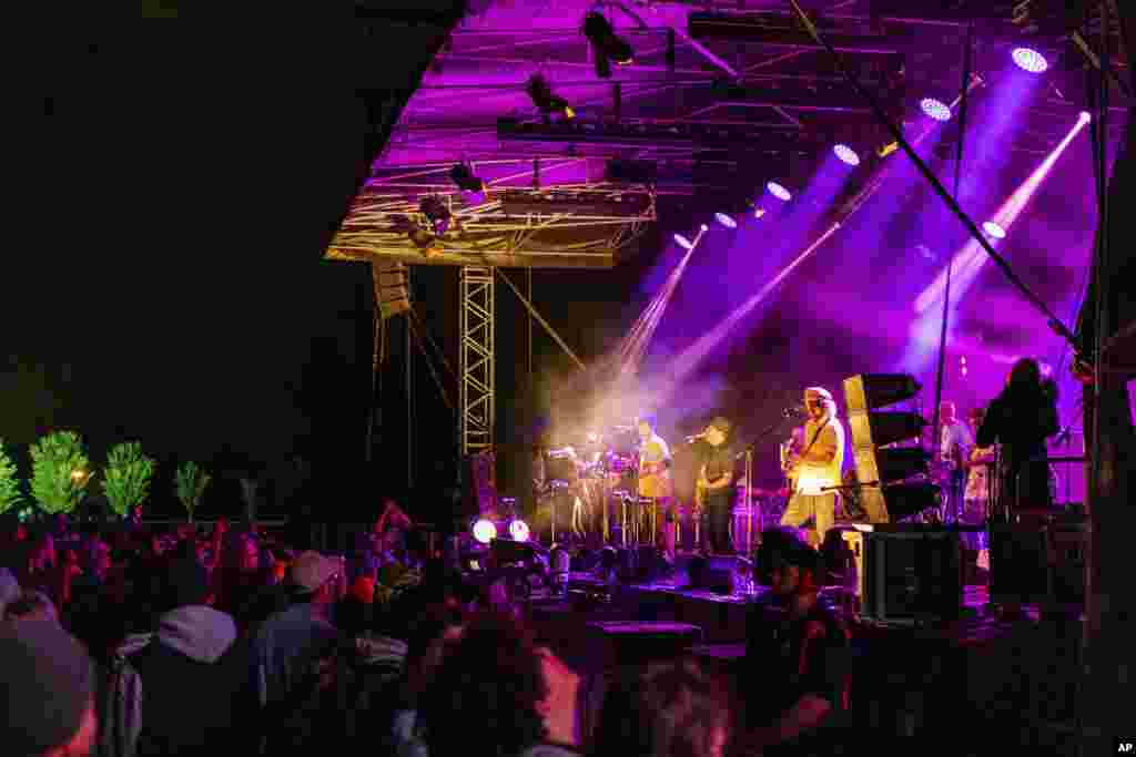 People watch New Zealand band The Black Seeds perform during New Year&#39;s Eve celebrations at Hagley Park in Christchurch, New Zealand, Jan. 1, 2021.