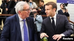 France's President Emmanuel Macron, right, and President of the European Commission Jean-Claude Juncker speak during the informal meeting of European Union leaders in Sibiu, Romania, May 9, 2019.