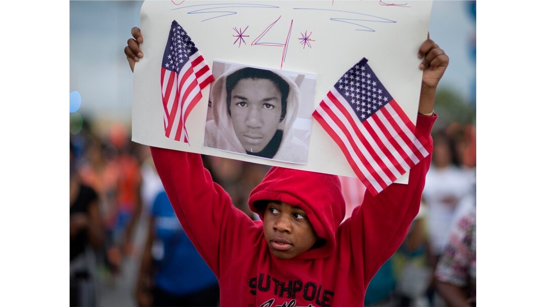 FILE - Jaylen Reese, 12, of Atlanta, marches during a protest of George Zimmerman's not guilty verdict in the 2012 shooting death of teenager Trayvon Martin, Atlanta, Georgia, July 15, 2013.