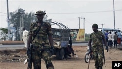 Soldiers stand guard outside the polling station during gubernatorial elections, Kaduna, April 28, 2011