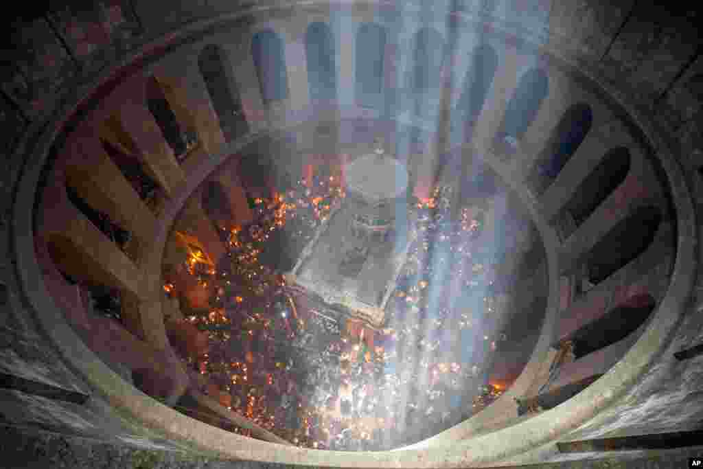Christian pilgrims hold candles as they gather during the ceremony of the Holy Fire at Church of the Holy Sepulchre, where many Christians believe Jesus was crucified, buried and rose from the dead, in the Old City of Jerusalem, May 1, 2021.