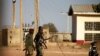 Military men walk inside the Government Science school in Kankara, in northwestern Katsina state, Nigeria, Dec. 13, 2020.