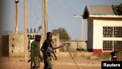 Military men walk inside the Government Science school in Kankara, in northwestern Katsina state, Nigeria, Dec. 13, 2020.