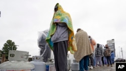 Carlos Mandez waits in line to fill his propane tank Feb 17, 2021, in Houston as millions in Texas had no power after a historic snowfall and single-digit temperatures created a surge of demand for electricity to warm up homes facing widespread blackouts.