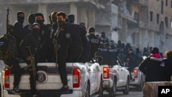 Syrian security forces leave the area after an operation in Tadamon, a suburb of Damascus, Syria, Feb. 17, 2025. Three individuals were arrested, accused of being involved in the execution of hundreds of civilians by government forces in Tadamon in 2013.