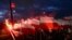 FILE - Demonstrators burn flares and wave Polish flags during an annual march to mark Poland's National Independence Day, in Warsaw, Poland, Nov. 11, 2017. 