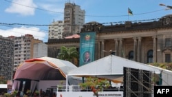 Trabalhadores preparam o local antes da cerimónia de tomada de posse do Presidente eleito de Moçambique, Daniel Chapo, na Praça da Independência, em Maputo, a 14 de janeiro de 2025.