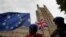Demonstrators waves flags near Parliament in London, Oct. 17, 2019. 