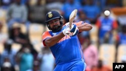 India's captain Rohit Sharma hits a 4 during the ICC men's Twenty20 World Cup 2024 Super Eight cricket match between Australia and India at Daren Sammy National Cricket Stadium in Gros Islet, Saint Lucia on June 24, 2024. (Photo by Chandan Khanna / AFP)