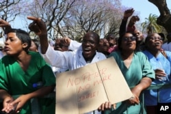 FILE - Zimbabwean medical staff march in Harare, Sept. 19, 2019. Zimbabwean doctors protesting the alleged abduction of a union leader won a high court ruling allowing them to march and handover a petition to the parliament.