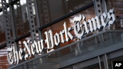 FILE - In this Thursday, May 6, 2021 file photo, a sign for The New York Times hangs above the entrance to its building, in New York. Numerous websites were unavailable on Tuesday June 8, 2021, after an apparent widespread outage at cloud service…