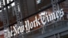 FILE - In this Thursday, May 6, 2021, photo, a sign for The New York Times hangs above the entrance to its building, in New York.