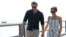 Britain's Prince Harry, left, and Meghan, Duchess of Sussex walk along Kingfisher Bay Jetty during a visit to Fraser Island, Australia, Oct. 22, 2018.
