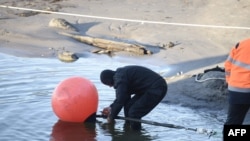 FILE - This picture taken on October 12, 2015 shows the C-Lion1 submarine telecommunications cable being laid to the bottom Baltic Sea from a military base in Helsinki, Finland. It was one of two cables in the Baltic Sea that had been cut in recent days.