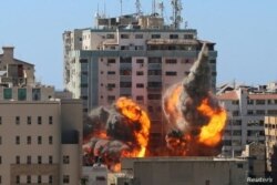 El edificio de al-Jalaa que alberga las oficinas de medios de Associated Press (AP) y Al Jazeera es impactado por un ataque aéreo israelí en la ciudad de Gaza, el 15 de mayo de 2021.