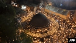 FILE—Ethiopian Orthodox Christian pilgrims mark"Holy Fire" ceremony at the Deir Al-Sultan Monastery on the roof of Holy Sepulchre Church in Jerusalem's Old City on May 04 2024.