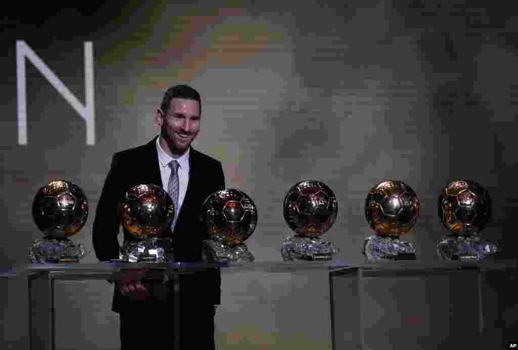 Barcelona&#39;s soccer player Lionel Messi poses with his six golden balls during the Golden Ball award ceremony in Paris, France, Dec. 2, 2019.