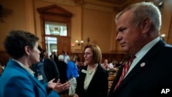 Georgia State Election Board members Sara Tindall Ghazal, Janice Johnston and executive director Mike Coan, from left, speak ahead of a meeting at the state Capitol, Sept. 20, 2024, in Atlanta.