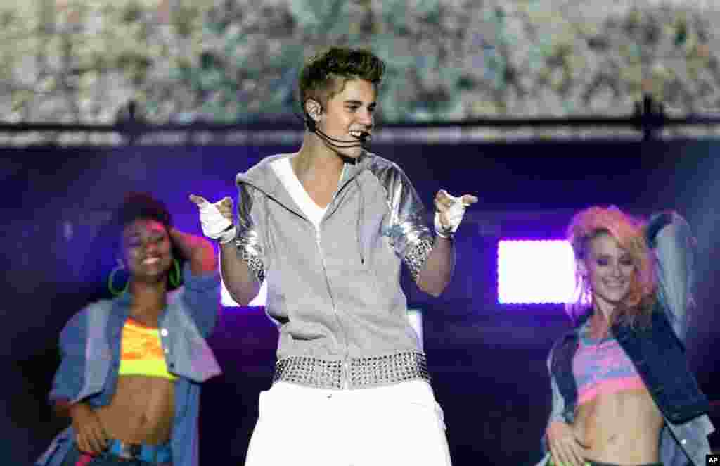 Pop star Justin Bieber, front, performs during a free open-air concert in Mexico City, June 11, 2012.