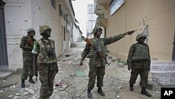 In this photo released by the African Union-United Nations Information Support Team, Ugandan soldiers serving with AMISOM patrol through the deserted streets of Bakara Market in central Mogadishu, August 9, 2011 (file photo)
