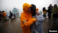 Family member of missing passengers who were on the South Korean ferry "Sewol" which sank in the sea off Jindo cry at a port where family members of missing passengers gathered in Jindo, April 18, 2014.