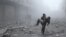 A wounded man is carried following an airstrike on the rebel-held besieged town of Arbin, in the eastern Ghouta region on the outskirts of the capital Damascus, Jan. 2, 2018.