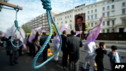 FILE - Mock nooses are displayed as supporters of the People's Mojahedin Organization of Iran (PMOI) take part in a demonstration outside the Iranian embassy in west London on July 31, 2010. 