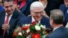 German president-elect, Frank-Walter Steinmeier, receives flowers after the first round of voting of the German presidential election at the Reichstag in Berlin, Feb. 12, 2017.