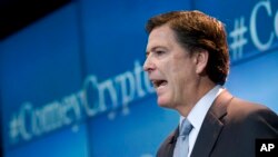 FBI Director James Comey warns of the impact of smart phone data encryption on law enforcement, Oct. 16, 2014, at Brookings Institution in Washington. 