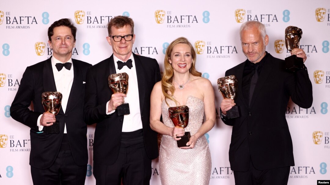 Graham Broadbent, Pete Czernin, and Martin Mcdonagh pose with their awards for Outstanding British Film for "The Banshees Of Inisherin" alongside Kerry Condon posing with her Best Supporting Actress award during the 2023 BAFTA Film Awards at the Royal Festival Hall in London, Feb. 19, 2023.