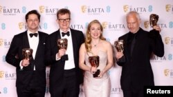 Graham Broadbent, Pete Czernin, and Martin Mcdonagh pose with their awards for Outstanding British Film for "The Banshees Of Inisherin" alongside Kerry Condon posing with her Best Supporting Actress award during the 2023 BAFTA Film Awards at the Royal Festival Hall in London, Feb. 19, 2023.