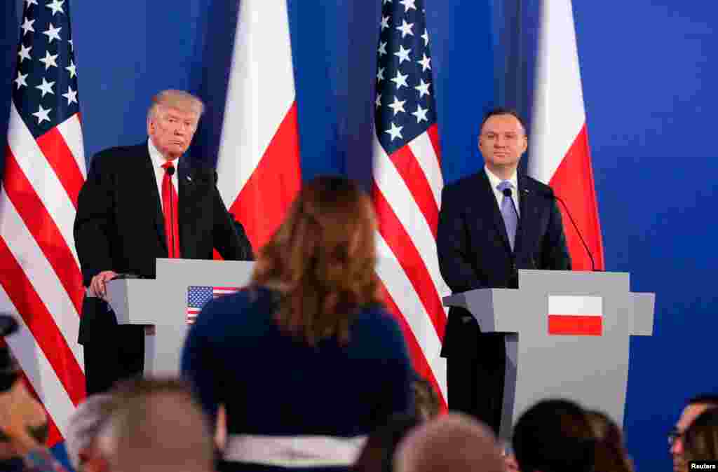 U.S. President Donald Trump and Polish President Andrzej Duda listen to questions from journalists during a joint news conference, in Warsaw, July 6, 2017.