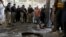 Police officers examine the site of bomb explosion in an Islamic seminary in Peshawar, Pakistan, Oct. 27, 2020. 