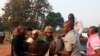 A man wounded in overnight clashes is assisted by peacekeepers and family members in a neighborhood in Bangui, Central African Republic, Dec. 23, 2013. 