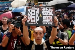 People demonstrate outside the police station during a protest against the Yuen Long attacks in Yuen Long, New Territories, Hong Kong, July 27, 2019.