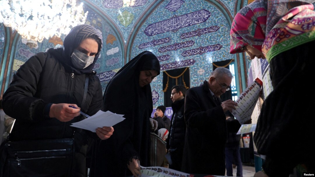 Iranians vote during the parliamentary election at a polling station in Tehran, Iran, March 1, 2024. (West Asia News Agency via Reuters)
