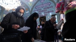 Iranians vote during the parliamentary election at a polling station in Tehran, Iran, March 1, 2024. (West Asia News Agency via Reuters)