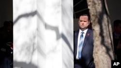 FILE - White House Social Media Director Dan Scavino listens to President Donald Trump speak during an event in the Rose Garden at the White House, Feb. 15, 2019.