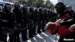 FILE - Law enforcement officers detain a participant in a rally in Moscow, Russia, Aug. 3, 2019. 