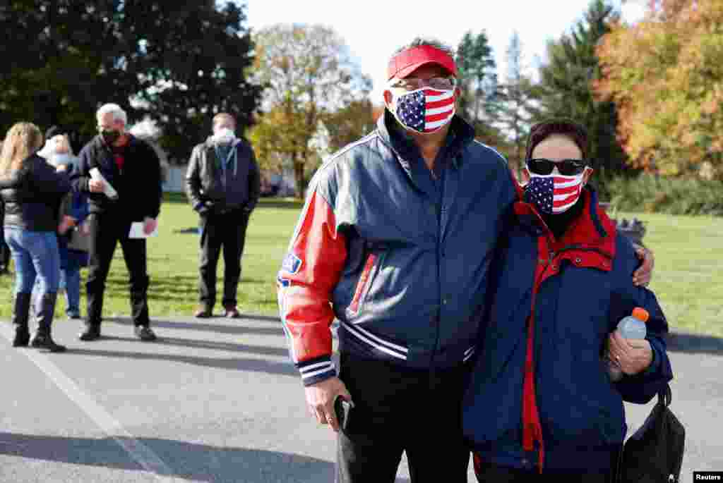 Voters Jim and Diane DiCarlo pose for a picture on Election Day near Dryland United Church of Christ in Lower Nazareth, Pennsylvania, Nov. 3, 2020. 