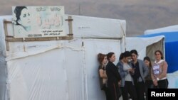 Displaced people from the Yazidi religious minority are seen at the Sharya camp, in Duhok, Iraq, Oct. 29, 2019. 